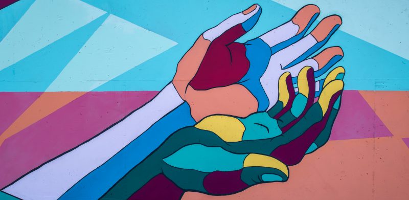 Abstract art of multicolored hands in offering